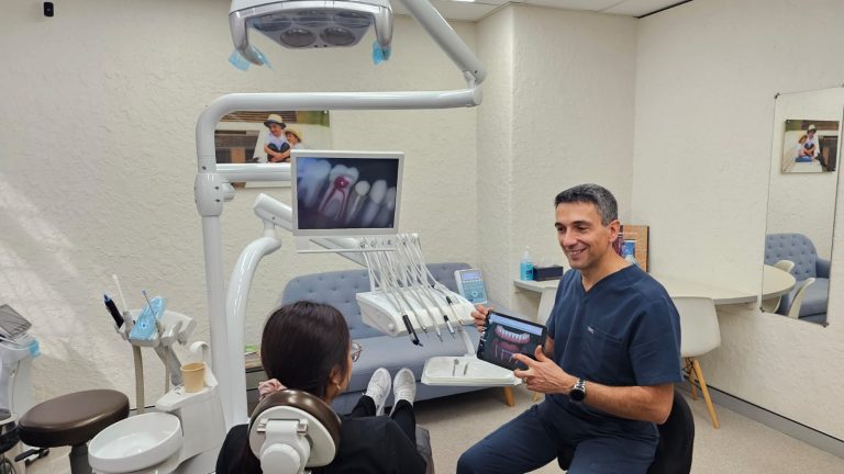 Dentist discussing All-on-4 treatment plan with patient during consultation at Perth Prime Dental
